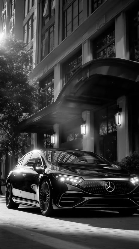 A black saloon outside a hotel entrance
